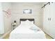 Bright bedroom featuring white shiplap accent wall and a cozy bed at 1809 Hawksbill Ln, St Cloud, FL 34771