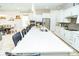 Spacious kitchen boasts a large island, stainless steel appliances, and white cabinetry at 1809 Hawksbill Ln, St Cloud, FL 34771