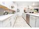 Bright kitchen with white cabinets, gray backsplash and long island at 1809 Hawksbill Ln, St Cloud, FL 34771