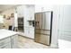Kitchen features stainless steel appliances and white cabinetry at 1809 Hawksbill Ln, St Cloud, FL 34771