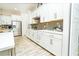 Modern kitchen with white cabinets, quartz countertops and tile flooring at 1809 Hawksbill Ln, St Cloud, FL 34771