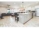 Open concept kitchen with island and gray cabinets at 1809 Hawksbill Ln, St Cloud, FL 34771