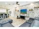 Open living area features a gray sectional sofa and a stone accent wall at 1809 Hawksbill Ln, St Cloud, FL 34771