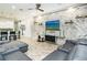 Living room with gray sectional sofa and a stone accent wall at 1809 Hawksbill Ln, St Cloud, FL 34771