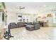 Spacious living room with gray sectional sofa and hardwood floors at 1809 Hawksbill Ln, St Cloud, FL 34771