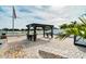 Pergola with seating area and table, perfect for outdoor dining at 1809 Hawksbill Ln, St Cloud, FL 34771