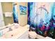 Bathroom with white vanity and dolphin-themed shower curtain at 1947 Quintilis Ct, Deltona, FL 32738