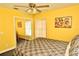 Yellow bedroom with ceiling fan and double bed at 1947 Quintilis Ct, Deltona, FL 32738