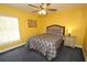 Yellow bedroom with ceiling fan and double bed at 1947 Quintilis Ct, Deltona, FL 32738