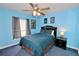 Blue bedroom with ceiling fan and double bed at 1947 Quintilis Ct, Deltona, FL 32738