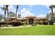 Brick home with lush landscaping and palm trees at 1947 Quintilis Ct, Deltona, FL 32738