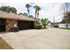 Attached garage with a dark brown door and AC unit at 1947 Quintilis Ct, Deltona, FL 32738