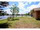 Brick home with a patio overlooking the lake at 1947 Quintilis Ct, Deltona, FL 32738
