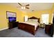 King-size bed, TV, and ceiling fan in this main bedroom at 1947 Quintilis Ct, Deltona, FL 32738