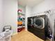 Laundry room with washer, dryer, and storage shelves at 2071 Remembrance Ave, St Cloud, FL 34769