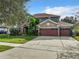 Two-story house with a three-car garage and manicured lawn at 2125 Tybee Rd, St Cloud, FL 34769