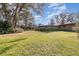 Expansive backyard featuring lush green grass and mature trees creating a private outdoor oasis at 2351 Mandarin Rd, Deland, FL 32720