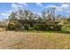 The lush, green backyard features a screened porch with a view of the lawn at 2351 Mandarin Rd, Deland, FL 32720