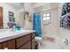 Cozy bathroom features a shower-tub combo, dark wood vanity, and ample lighting at 2351 Mandarin Rd, Deland, FL 32720