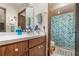 A bright bathroom with a wooden vanity, charming shower curtain, and ample counter space at 2351 Mandarin Rd, Deland, FL 32720