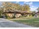 Charming single-story brick home with a well-manicured lawn and mature trees at 2351 Mandarin Rd, Deland, FL 32720