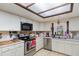 A cozy kitchen with white cabinets, stainless steel appliances, and natural lighting from a skylight at 2351 Mandarin Rd, Deland, FL 32720