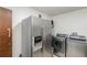 Modern laundry room featuring stainless steel washer, dryer, and refrigerator for added convenience at 2351 Mandarin Rd, Deland, FL 32720