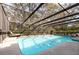 Sparkling screened-in pool offering a private and refreshing outdoor escape amidst tropical foliage at 2351 Mandarin Rd, Deland, FL 32720