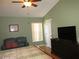 Primary bedroom with TV, dresser, and sitting area at 265 Kassik Cir, Orlando, FL 32824