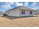 Home's backyard with covered patio and grassy area at 2860 Ne 42Nd Rd, Ocala, FL 34470