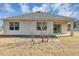 Home's backyard with covered patio and grassy area at 2860 Ne 42Nd Rd, Ocala, FL 34470