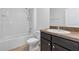 Clean bathroom with shower/tub combo, dark vanity, and tile flooring at 2860 Ne 42Nd Rd, Ocala, FL 34470