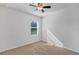 Bright bedroom with neutral walls, ceiling fan, and window at 2860 Ne 42Nd Rd, Ocala, FL 34470