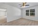 Bright bedroom with window, ceiling fan, and neutral carpeting at 2860 Ne 42Nd Rd, Ocala, FL 34470