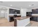 Modern kitchen with island, dark cabinets, and granite counters at 2860 Ne 42Nd Rd, Ocala, FL 34470