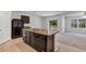 Modern kitchen with island, dark cabinets, and granite counters at 2860 Ne 42Nd Rd, Ocala, FL 34470