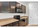 Kitchen with dark brown cabinets, granite countertops, and black appliances at 2860 Ne 42Nd Rd, Ocala, FL 34470