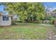 Backyard with a large tree and partial home view at 3501 Calumet Dr, Orlando, FL 32810