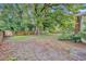 Large backyard with mature trees and a wooden fence at 3501 Calumet Dr, Orlando, FL 32810