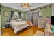 Main bedroom with hardwood floors and a dresser at 3501 Calumet Dr, Orlando, FL 32810