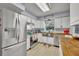 Modern kitchen with white cabinets, butcher block countertops and a farmhouse sink at 3501 Calumet Dr, Orlando, FL 32810