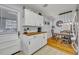 White kitchen cabinets, butcher block countertops, and a breakfast nook at 3501 Calumet Dr, Orlando, FL 32810