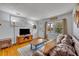 Living room with hardwood floors, a large window and comfortable seating at 3501 Calumet Dr, Orlando, FL 32810
