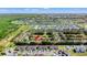 Aerial view of townhouse community surrounded by trees with neighborhood of homes nearby at 3632 Calabria Ave, Davenport, FL 33897