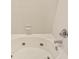Close up of jacuzzi tub with jets, white tile backsplash, and chrome fixtures at 3632 Calabria Ave, Davenport, FL 33897