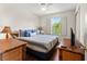 Cozy bedroom with blue accents, bamboo furniture, wood floors, and natural light at 3632 Calabria Ave, Davenport, FL 33897