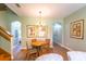 A charming dining area with a wooden table and chairs, complemented by elegant lighting and wall decor at 3632 Calabria Ave, Davenport, FL 33897