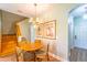 Cozy dining area near the stairs with a charming wooden table and chairs, illuminated by a decorative chandelier at 3632 Calabria Ave, Davenport, FL 33897