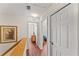 Upstairs hallway leads to bedrooms, with art decorating the walls and wood-look floors at 3632 Calabria Ave, Davenport, FL 33897