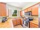 Well-equipped kitchen with light wood cabinets, granite countertops, and stainless steel appliances at 3632 Calabria Ave, Davenport, FL 33897